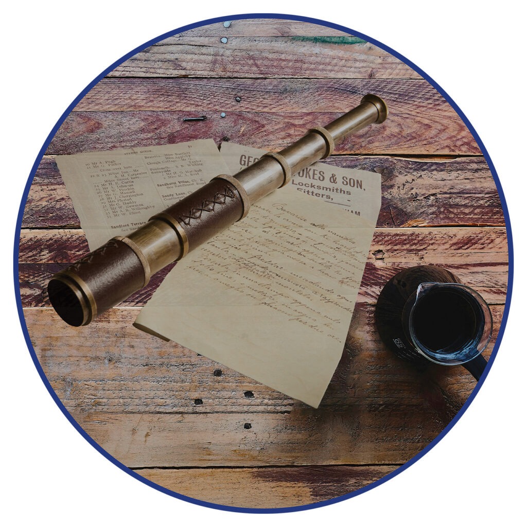 Image shows an ornamental brass and leather telescope lies on a wooden table with some papers made to make it look like it's old and not a modern recreation made overseas.
