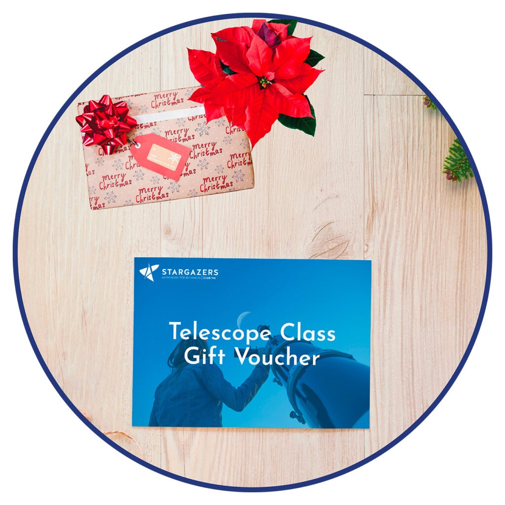 A Stargazers Club WA telescope class gift certificate sits on a table with a wrapped Christmas gift and a poinsettia plant