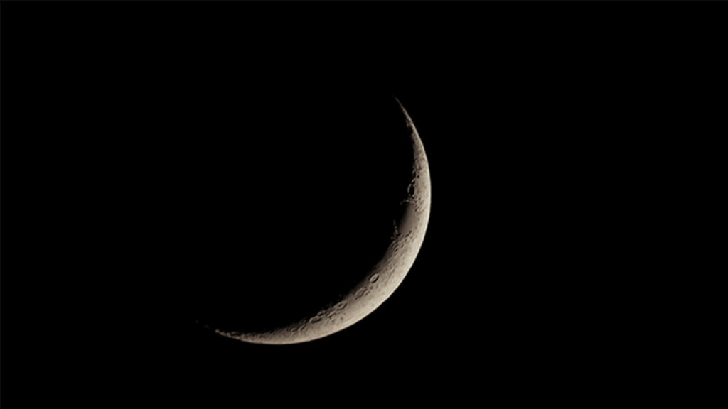 Waxing crescent moon seen with telescope