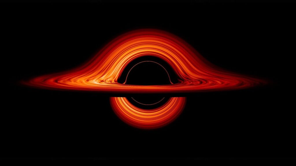 A black hole's extreme gravity skews light emitted by different regions of the disk, producing a misshapen appearance of glowing orange and red swirling light and energy against a black background.