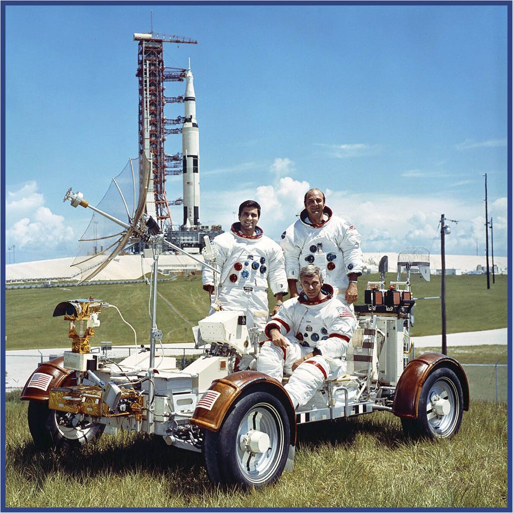 Moon facts #6: Three astronauts posing for press photographs with the lunar rover vehice and the Saturn rocket in the background.